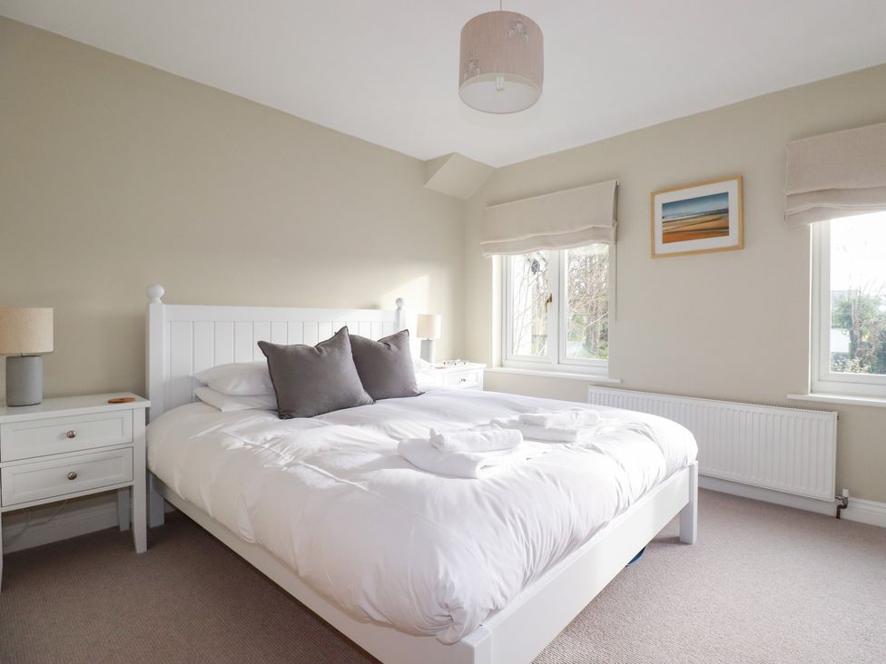 A bedroom with a bed and bedside table at The Mizzen St Endellion near Port Isaac
