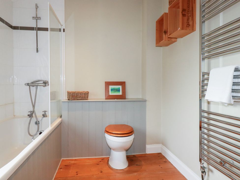 A bathroom featuring a bathtub, toilet, and towel rack at The Mizzen in St Endellion near Port Isaac
