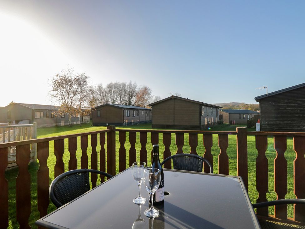 An outdoor area with a table and chairs at Bluebell Lodge in Warton