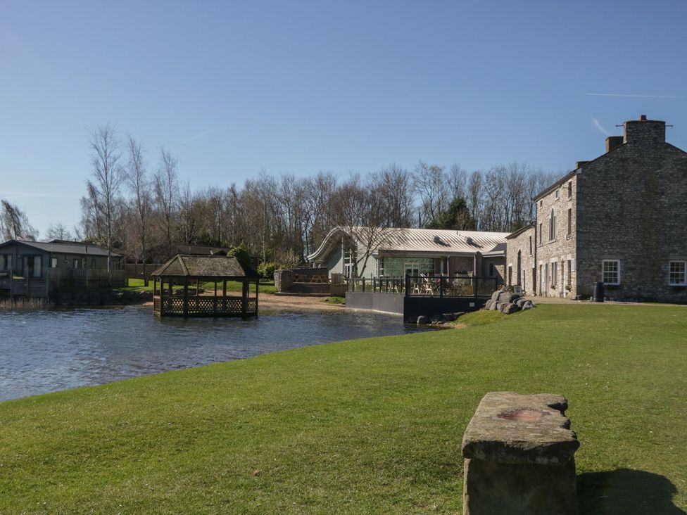 An outdoor area with a gazebo and buildings at Bluebell Lodge in Warton