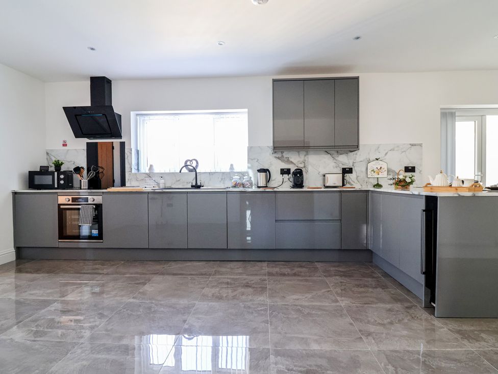 A kitchen with cabinets, countertops and appliances at 1 Talbot Drive in Talacre