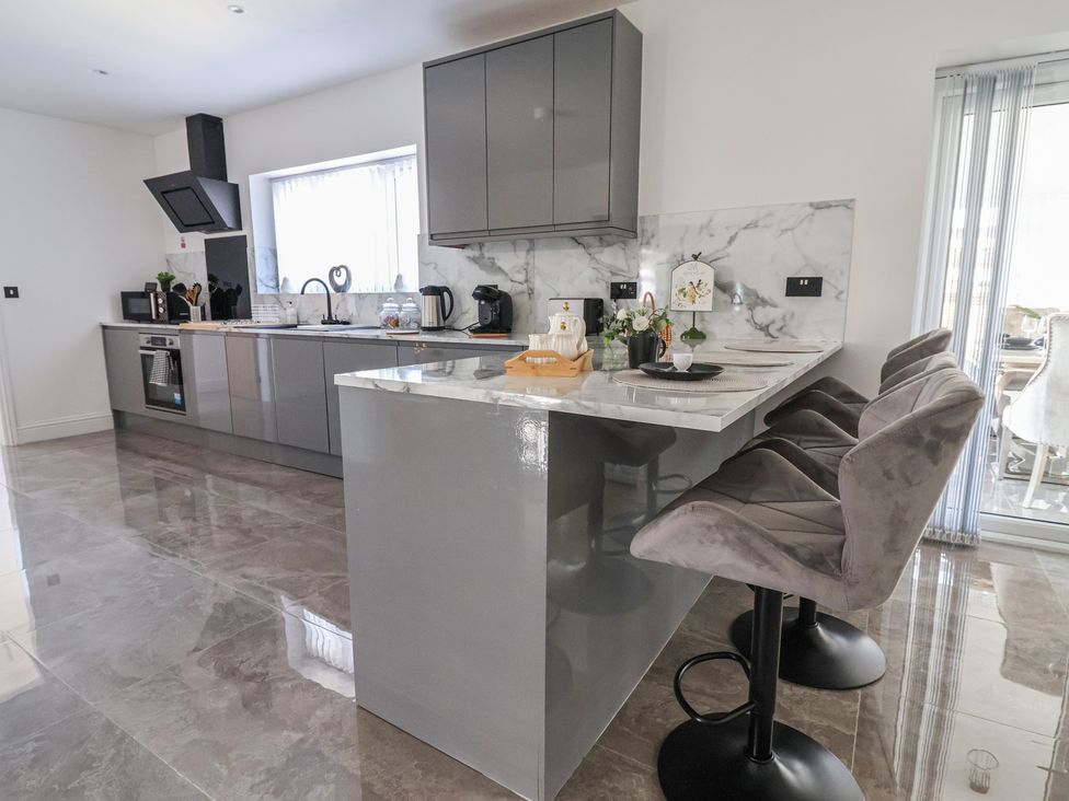 A kitchen with modern cabinets and appliances at 1 Talbot Drive Talacre