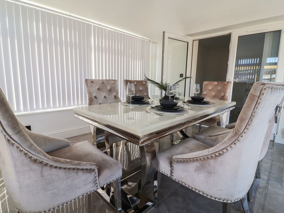 A dining room with a table and chairs at 1 Talbot Drive Talacre