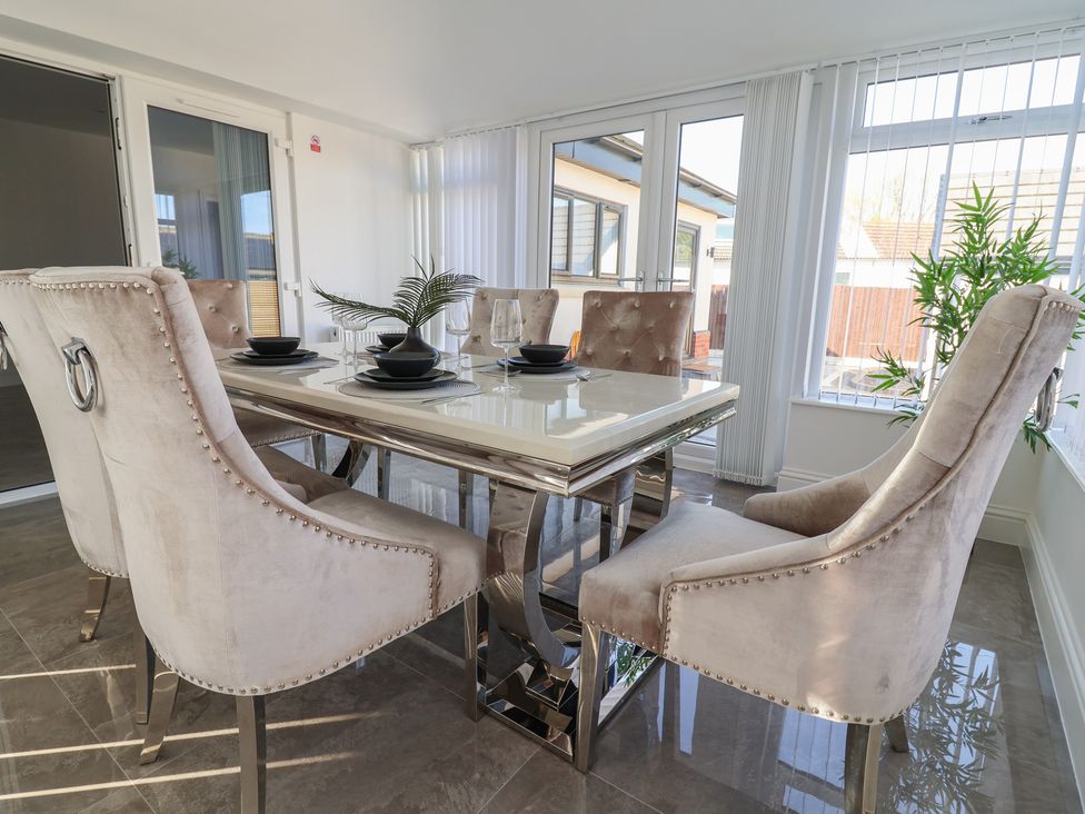 A dining room with a table and chairs at 1 Talbot Drive Talacre