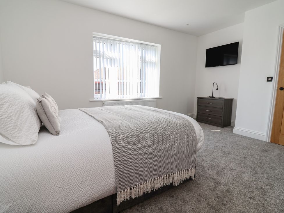 A bedroom with a bed and television at 1 Talbot Drive in Talacre