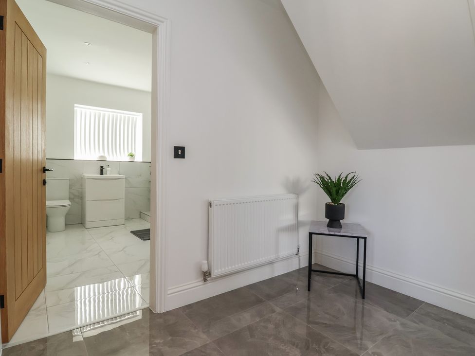 A bathroom with a sink and toilet visible at 1 Talbot Drive, Talacre