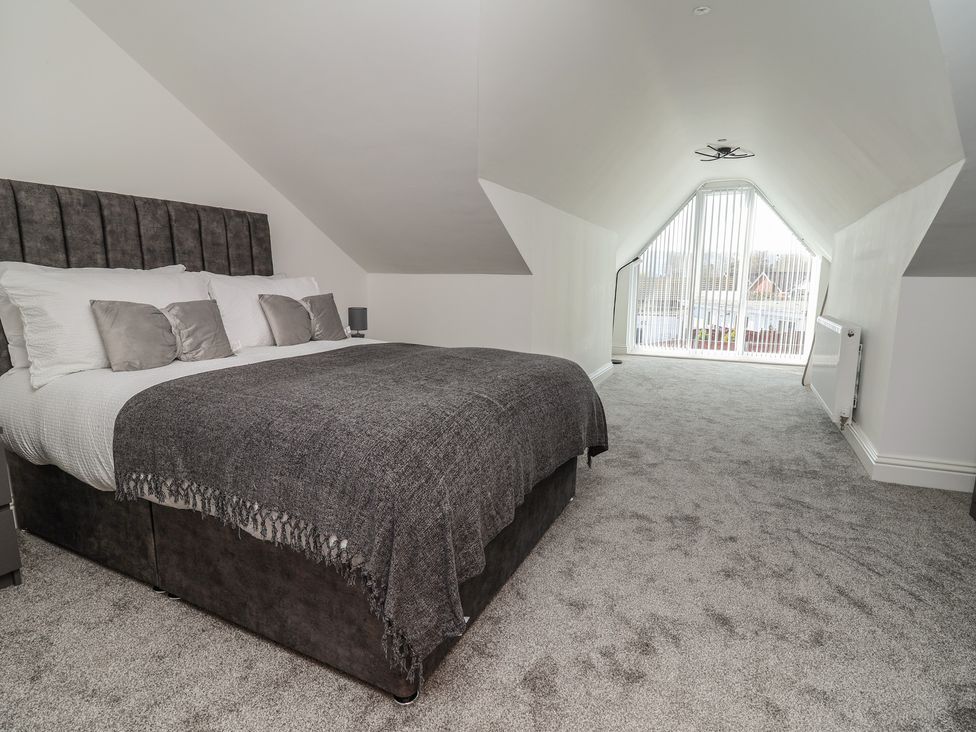 A bedroom with a bed and window at 1 Talbot Drive in Talacre