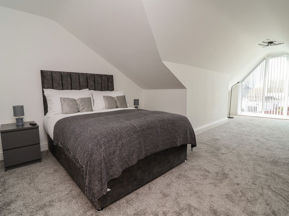 A bedroom with a bed and a nightstand at 1 Talbot Drive Talacre
