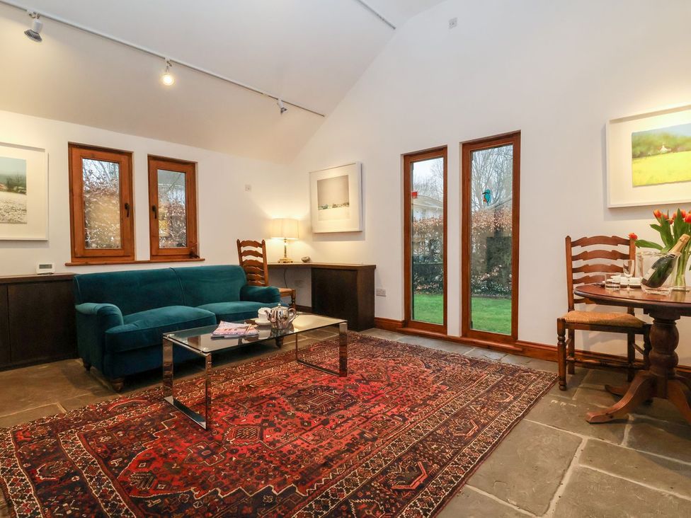 A living room with a sofa and coffee table at Owl Cottage in Woodbridge