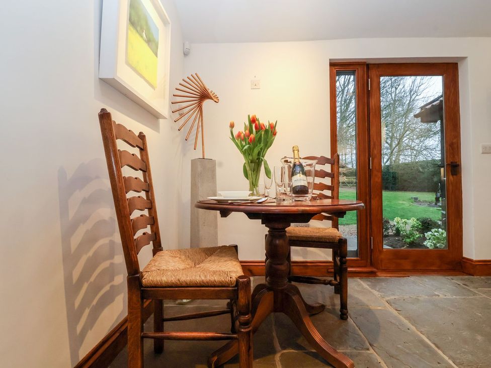 A dining room with a table and chairs at Owl Cottage in Woodbridge