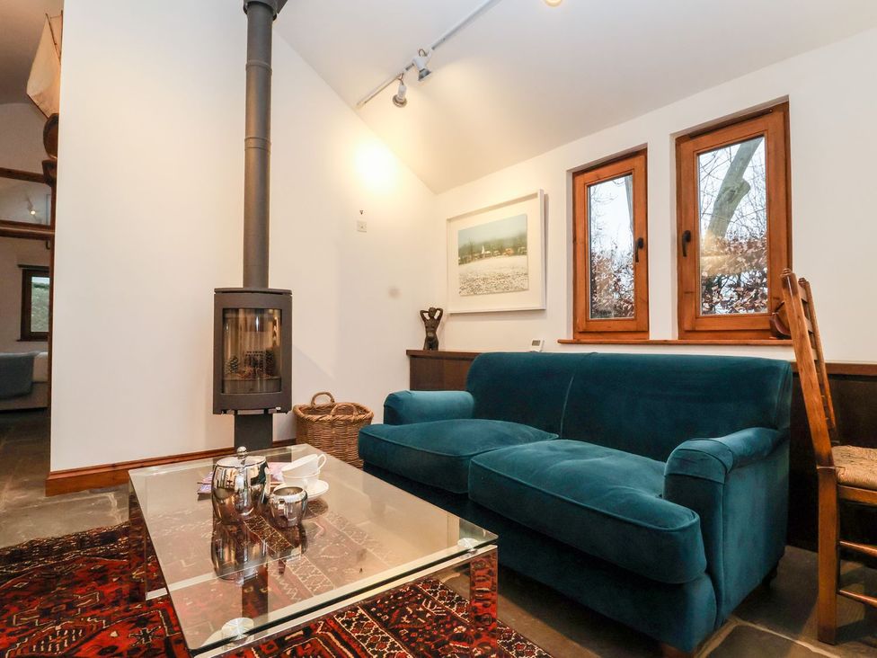 A living room with a couch and coffee table at Owl Cottage in Woodbridge