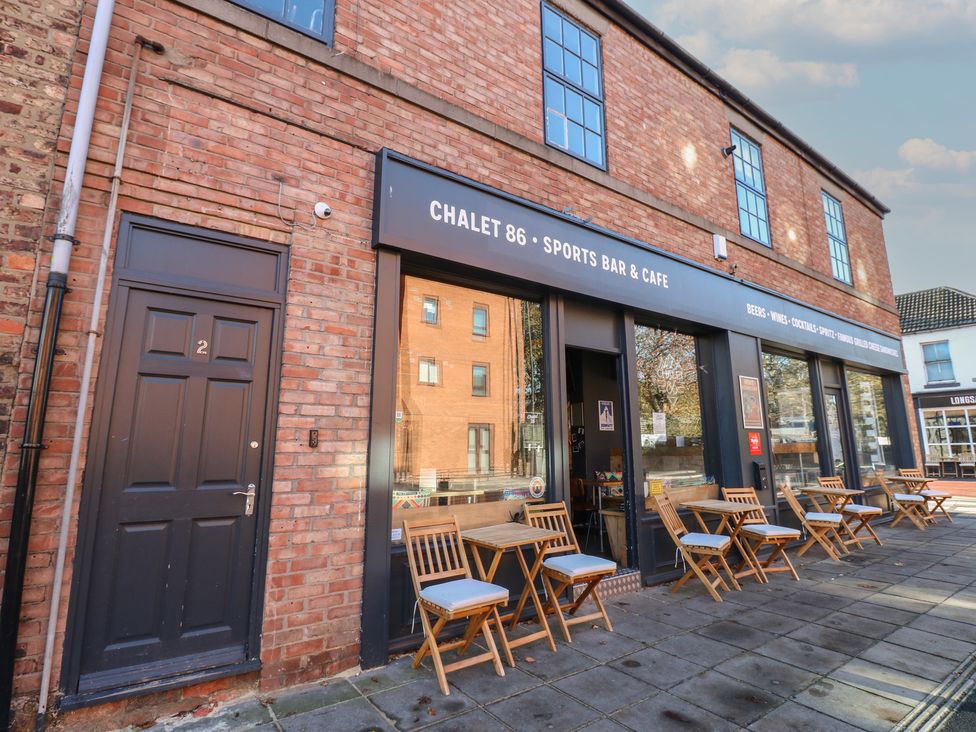 An outdoor seating area with tables at Chalet 86 in North Shields