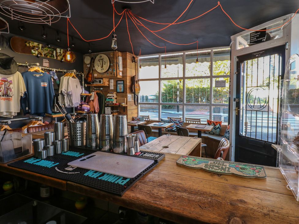 A cafe with a bar counter and clothing rack at Chalet 86 North Shields