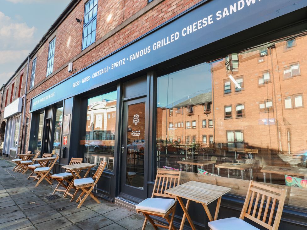 An outdoor seating area with tables and chairs at Chalet 86 in North Shields