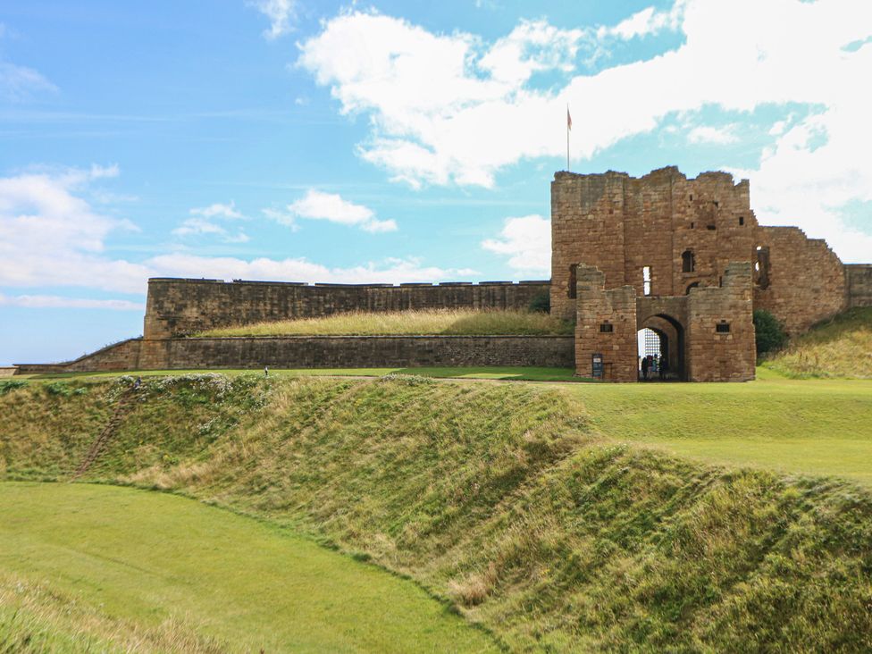 A castle with an archway and grassy hill at Chalet 86 in North Shields