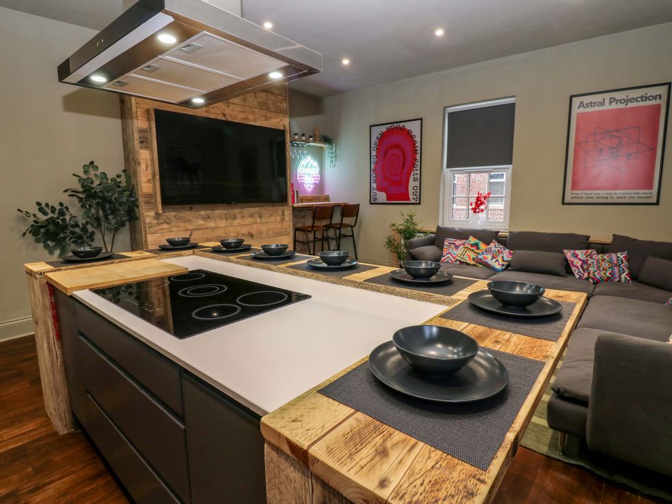 A kitchen with an island and seating area at Chalet 86 Tynemouth
