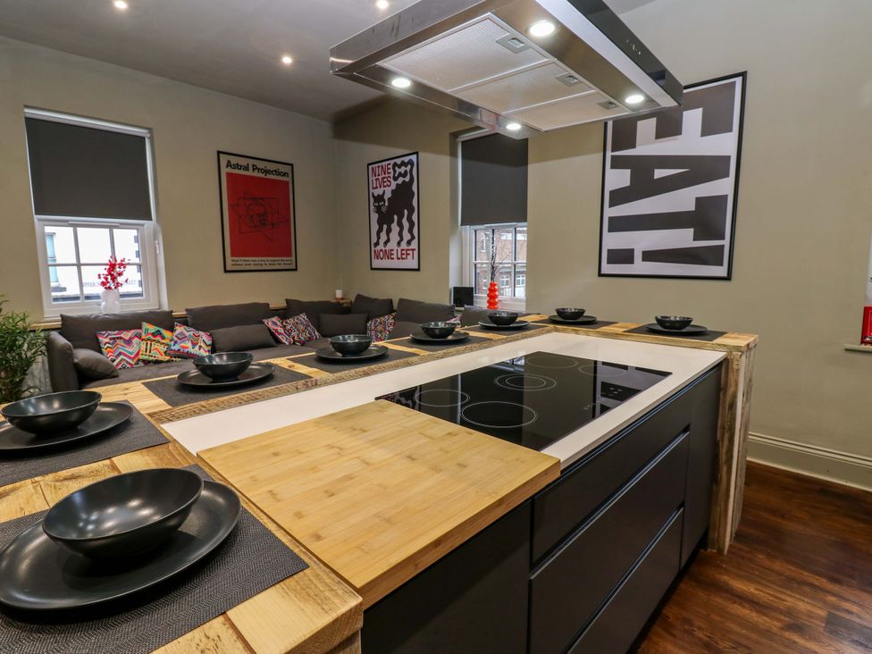 A kitchen with a kitchen island and seating at Chalet 86 Tynemouth