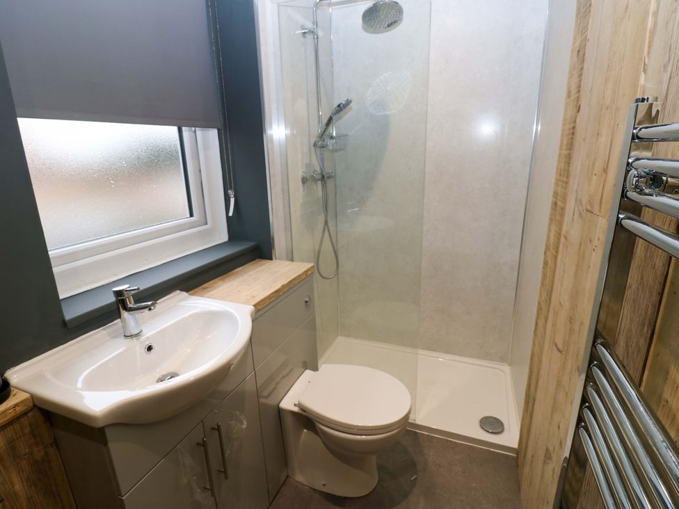 A bathroom with a sink, toilet, and shower at Chalet 86 Tynemouth