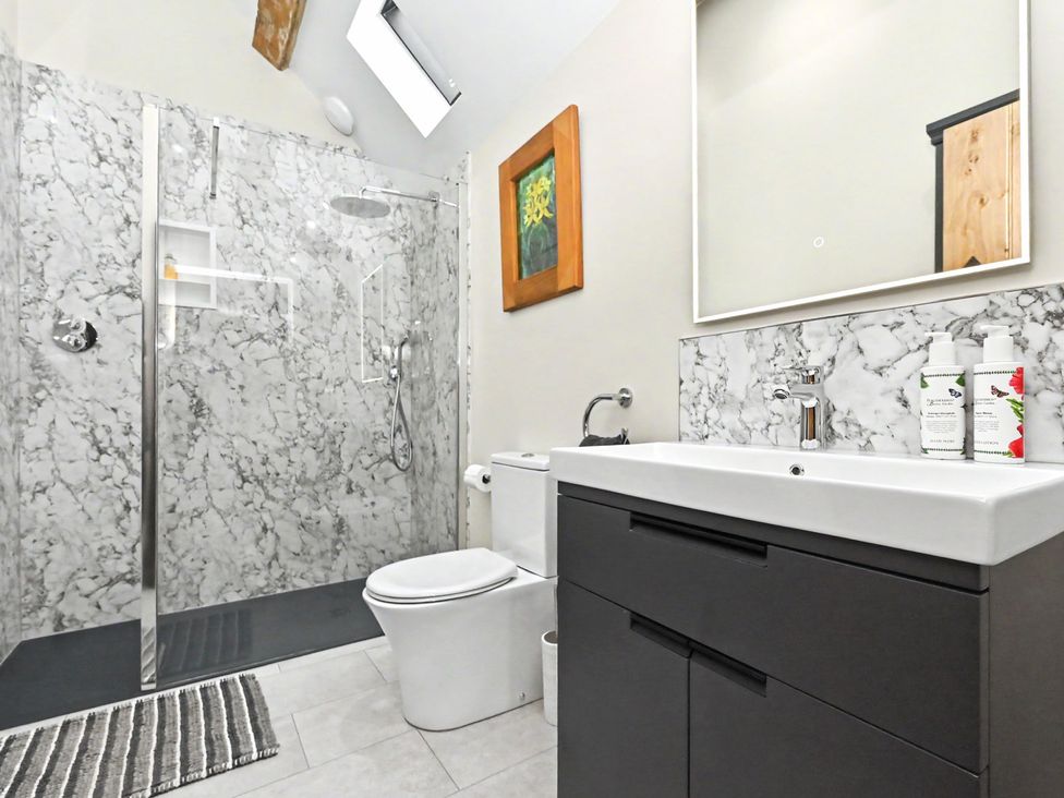 A bathroom with shower and sink at Lane House Farm Barn Butterton