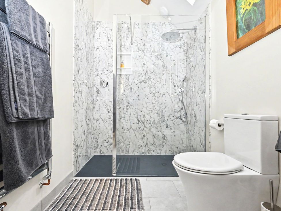 A bathroom with a shower and toilet at Lane House Farm Barn Butterton