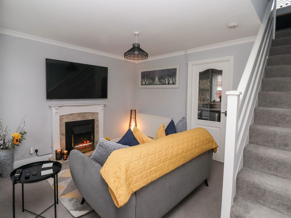 A living room with a sofa and television at 127 Bellhouse Way York