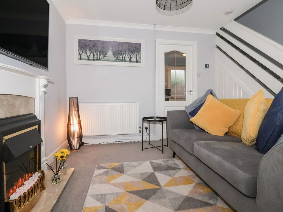 A living room with a sofa and television at 127 Bellhouse Way in York