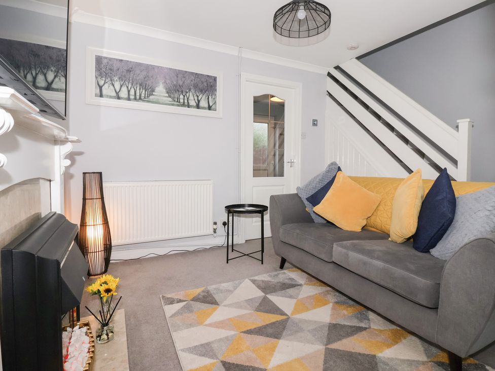 A living room with a sofa and coffee table at 127 Bellhouse Way in York