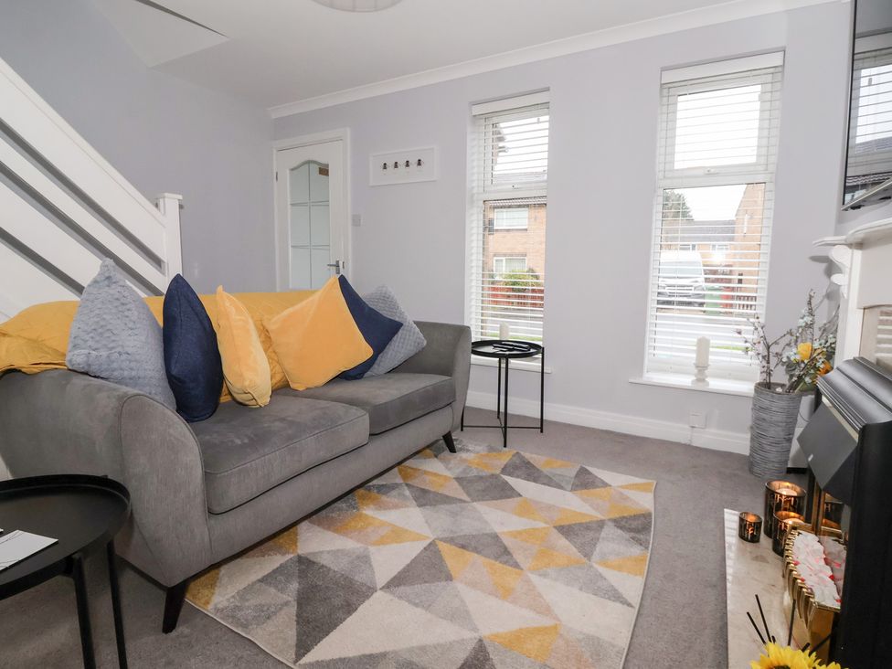 A living room with a sofa and side table at 127 Bellhouse Way York