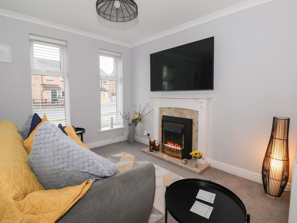 A living room with a sofa and television at 127 Bellhouse Way in York