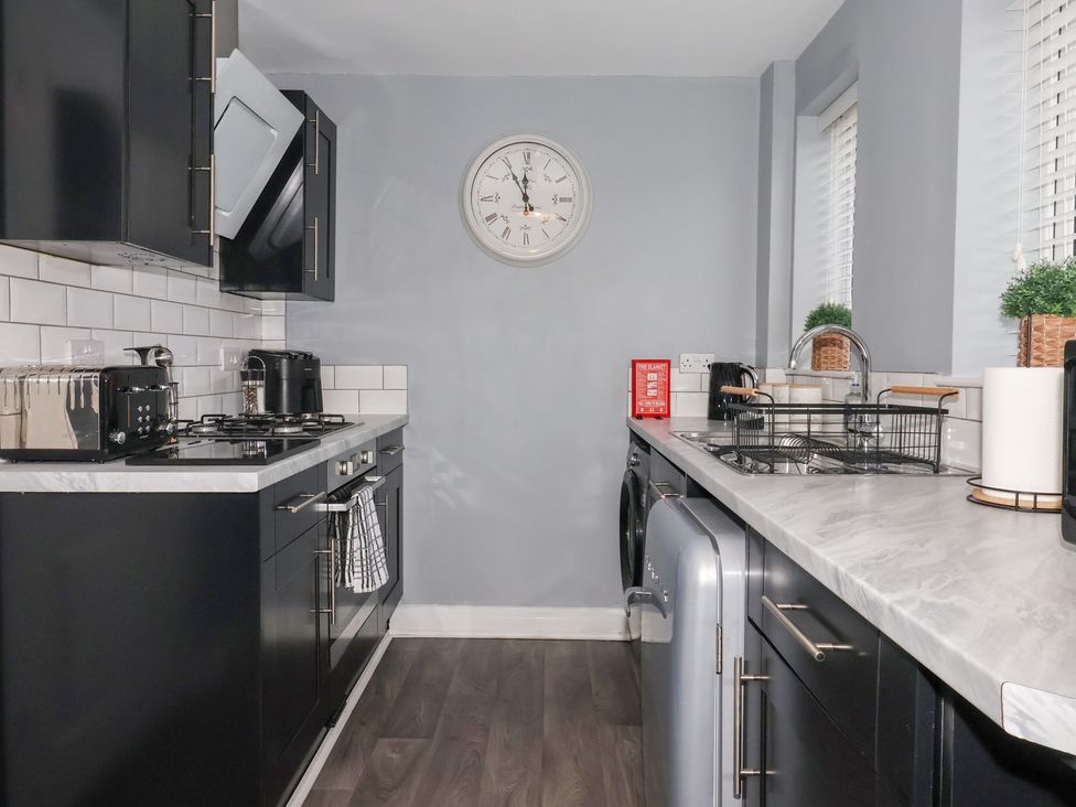 A kitchen with appliances and a clock at 127 Bellhouse Way in York