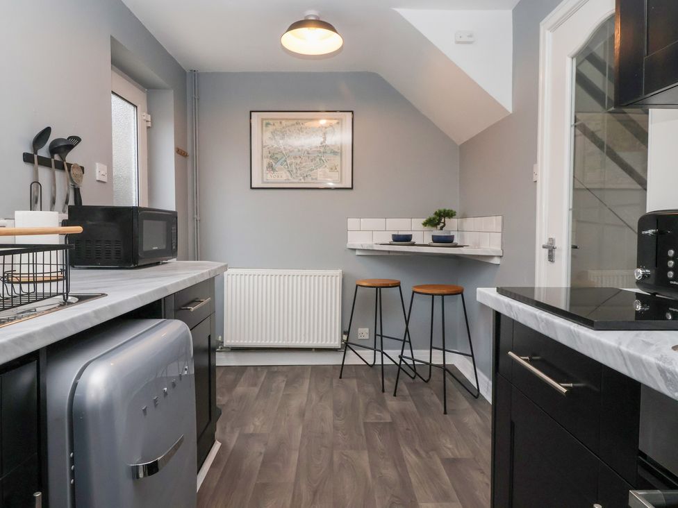 A kitchen with a microwave and a fridge at 127 Bellhouse Way in York