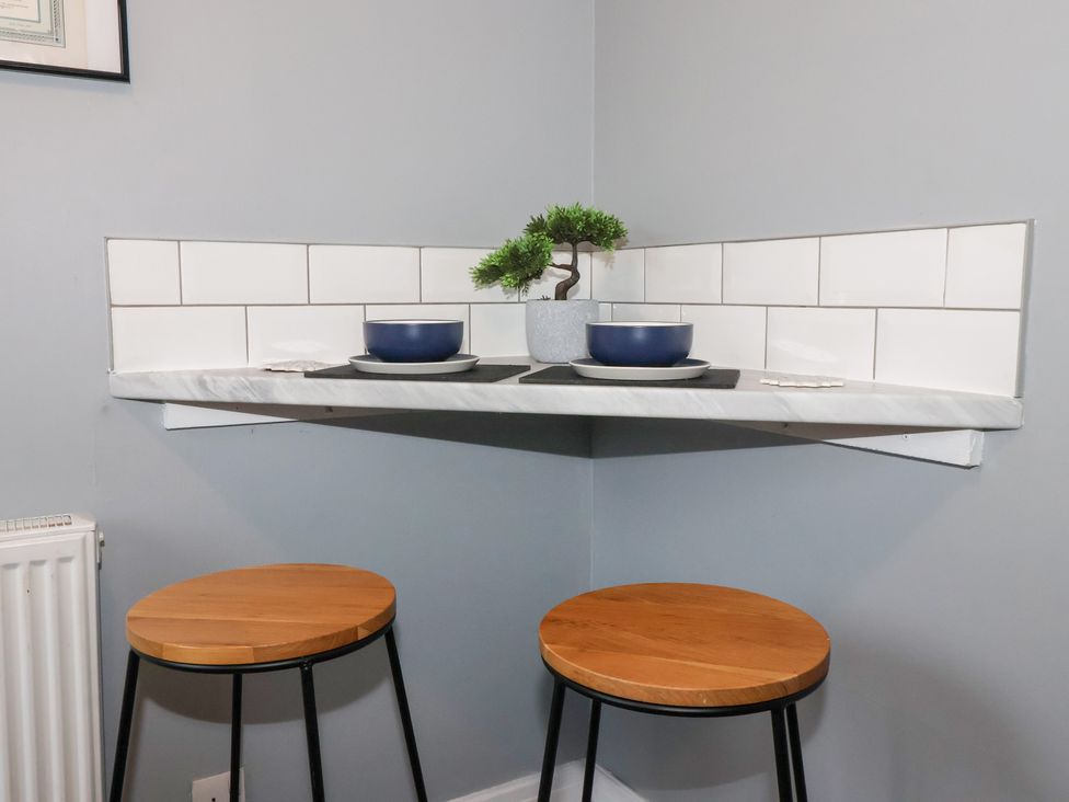 A corner shelf with a blue bowl and plant at 127 Bellhouse Way York