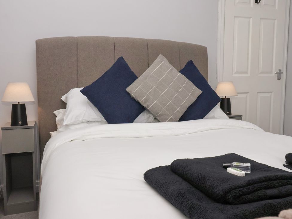A bedroom with a bed and bedside tables at 127 Bellhouse Way York