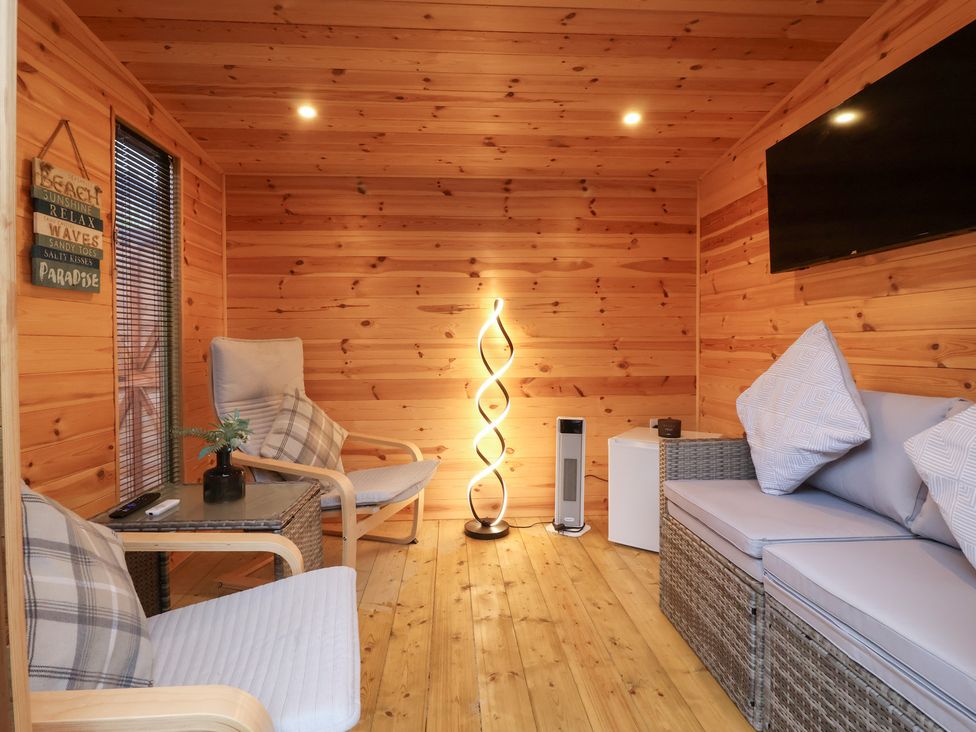 A room with a sofa and chairs at 127 Bellhouse Way, York