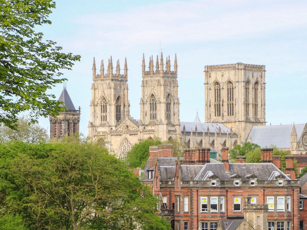 A cathedral with towers and surrounding buildings at 127 Bellhouse Way in York