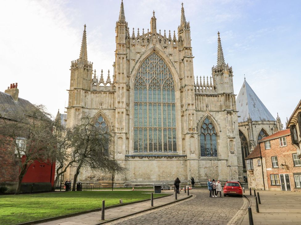A cathedral viewed from the street with people and a car at 127 Bellhouse Way York