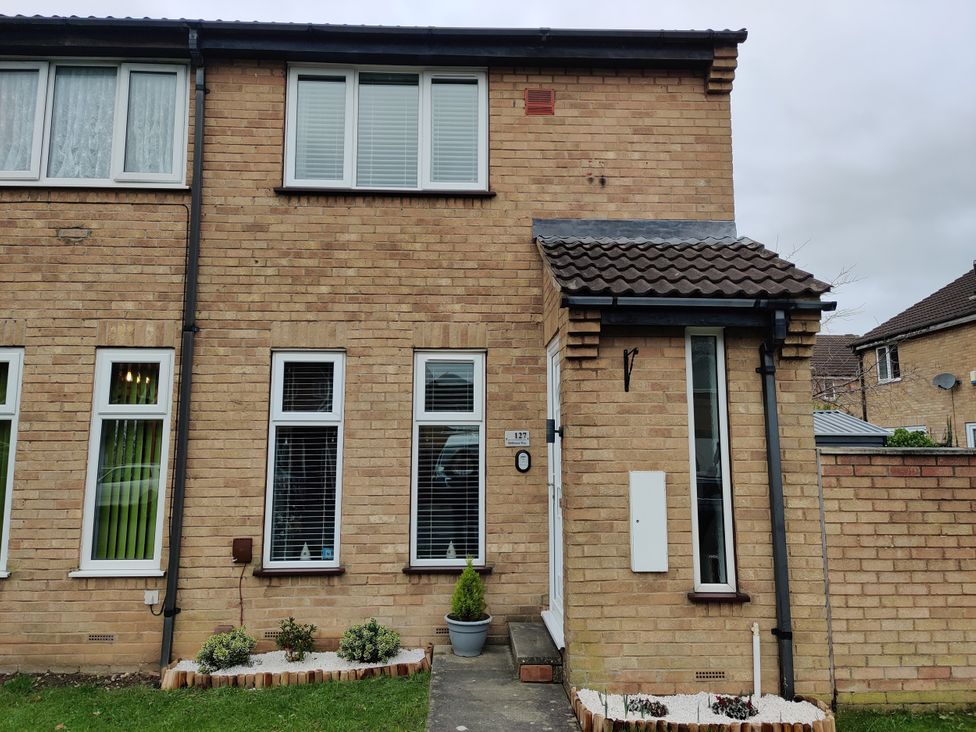 An exterior view of a house with windows and brick walls at 127 Bellhouse Way in York