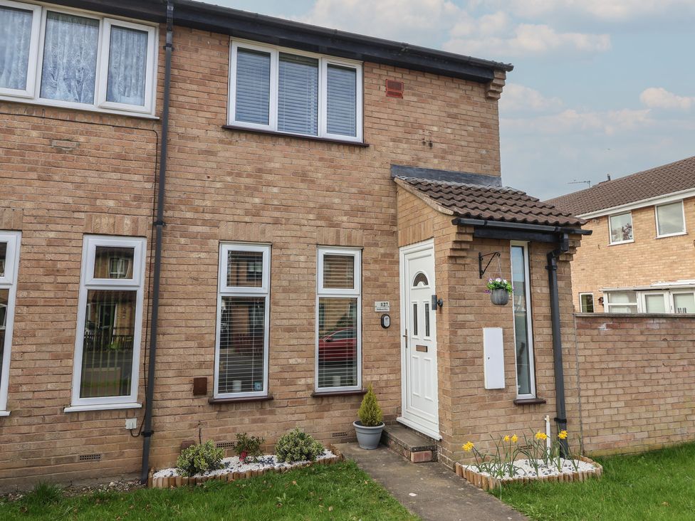 A front exterior view of a house with a door and windows at 127 Bellhouse Way in York