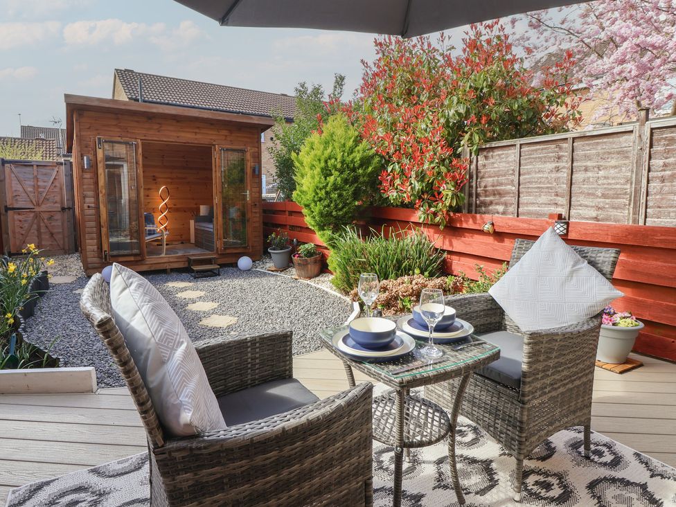 A garden with seating area and shed at 127 Bellhouse Way, York