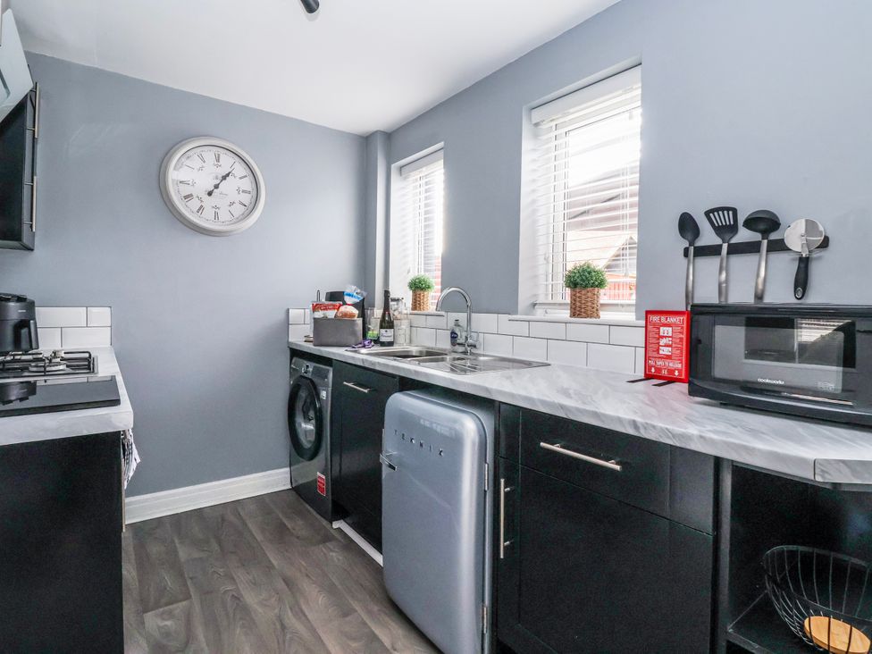 A kitchen with appliances and a washing machine at 127 Bellhouse Way in York