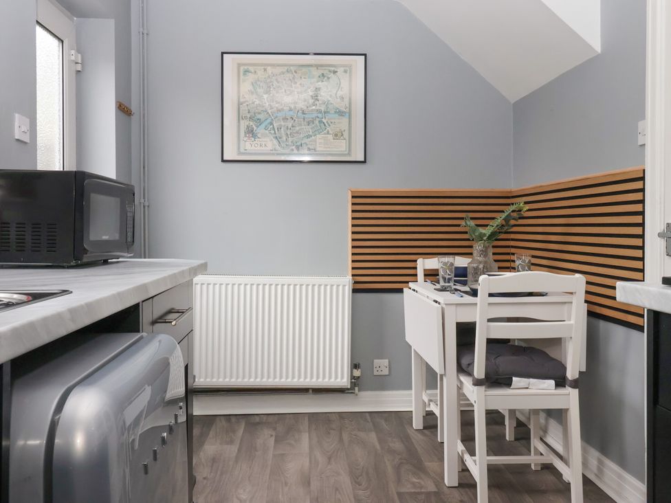 A kitchen with a table and chairs at 127 Bellhouse Way in York