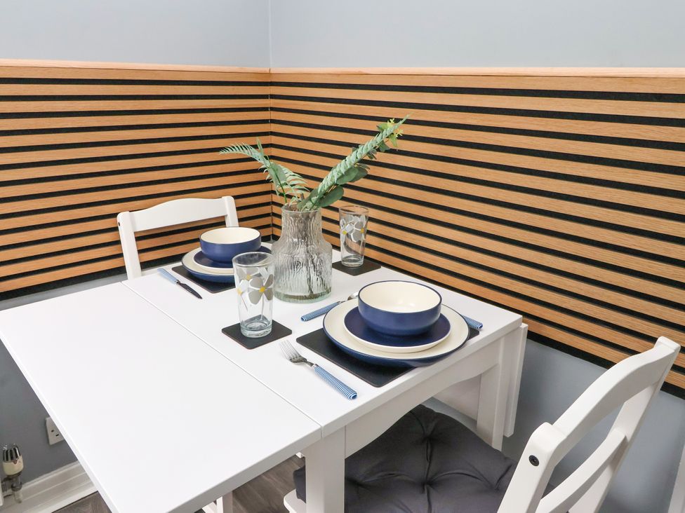 A dining room with a table set for two at 127 Bellhouse Way in York