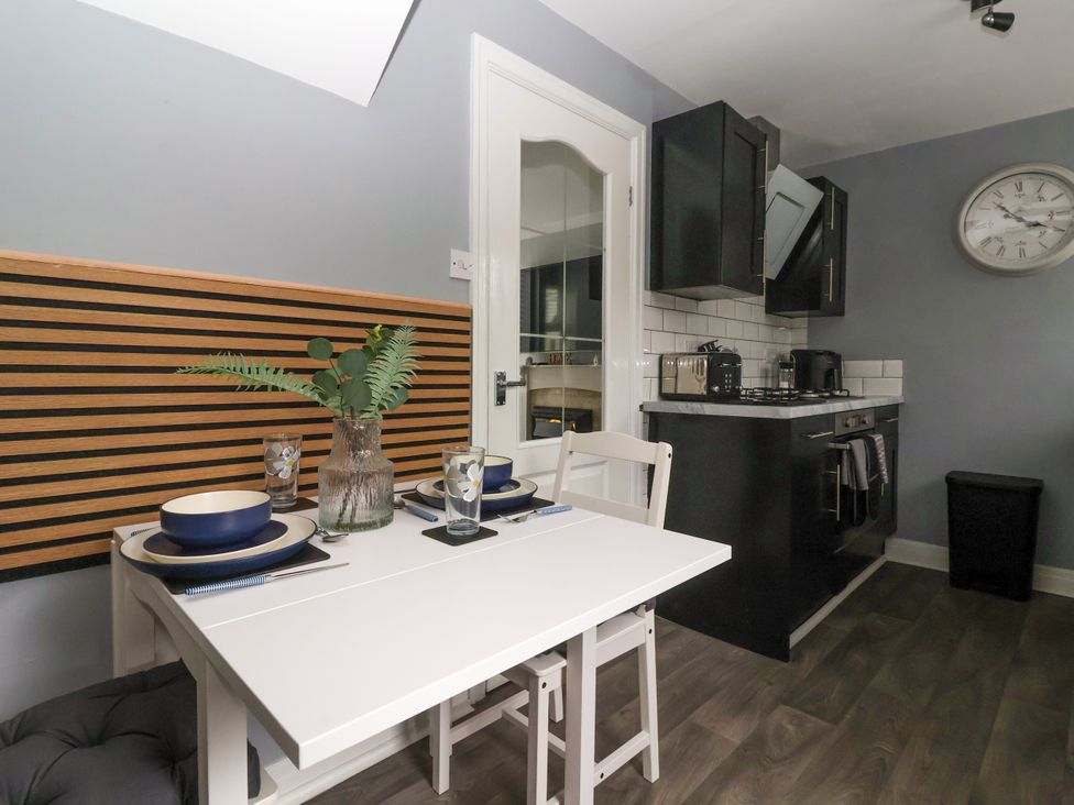 A kitchen with a dining table and chairs at 127 Bellhouse Way, York