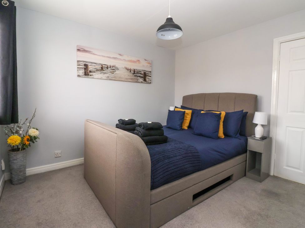 A bedroom with a bed and bedside table at 127 Bellhouse Way in York