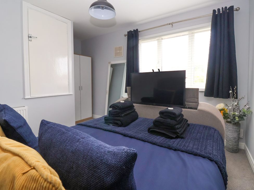 A bedroom with a bed and television at 127 Bellhouse Way in York