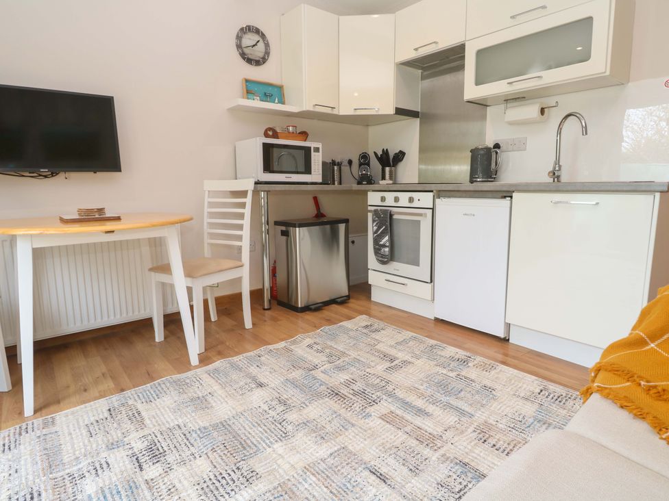A kitchen with appliances and seating area at Blake Lodge Crantock