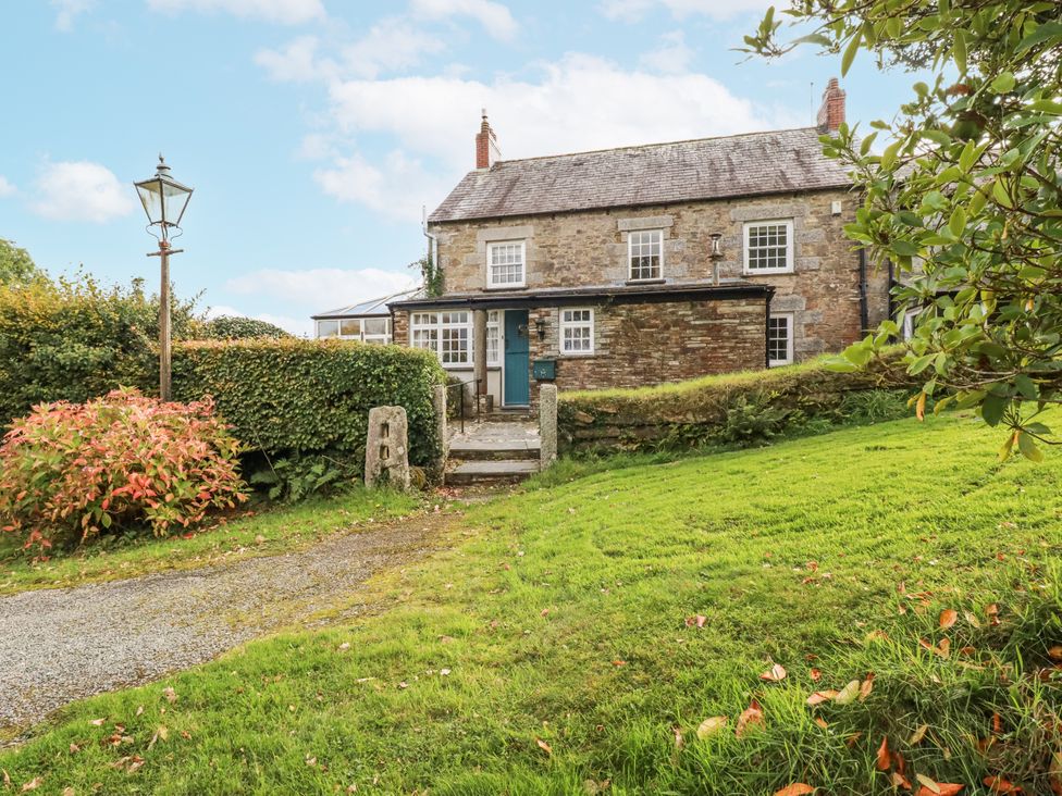 A house with a pathway and lamp post at Tresarrett Manor in Bodmin
