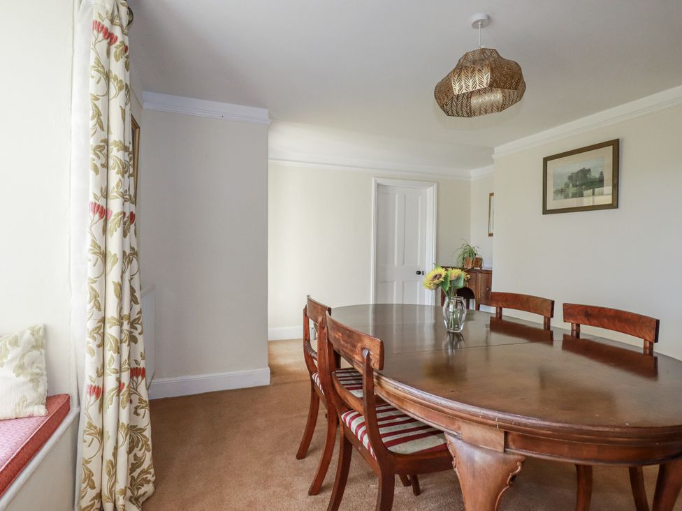 A dining room with a table and chairs at Tresarrett Manor in Bodmin