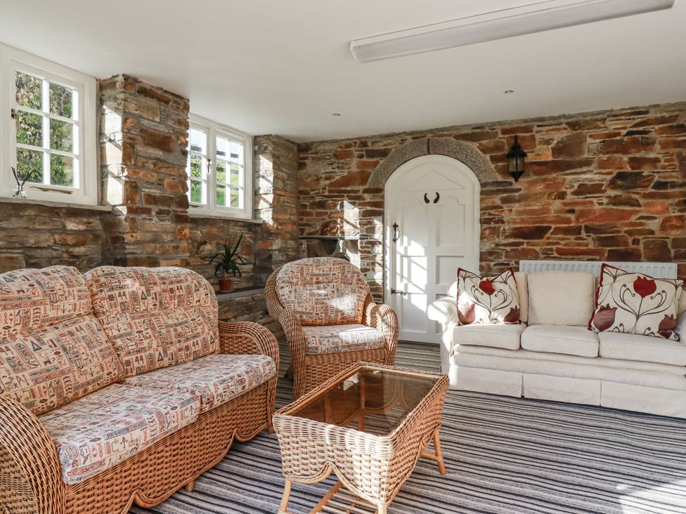 A snug with wicker seating and a coffee table at Tresarrett Manor in Bodmin