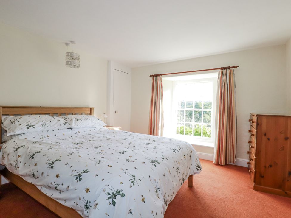 A bedroom with a bed and window at Tresarrett Manor in Bodmin
